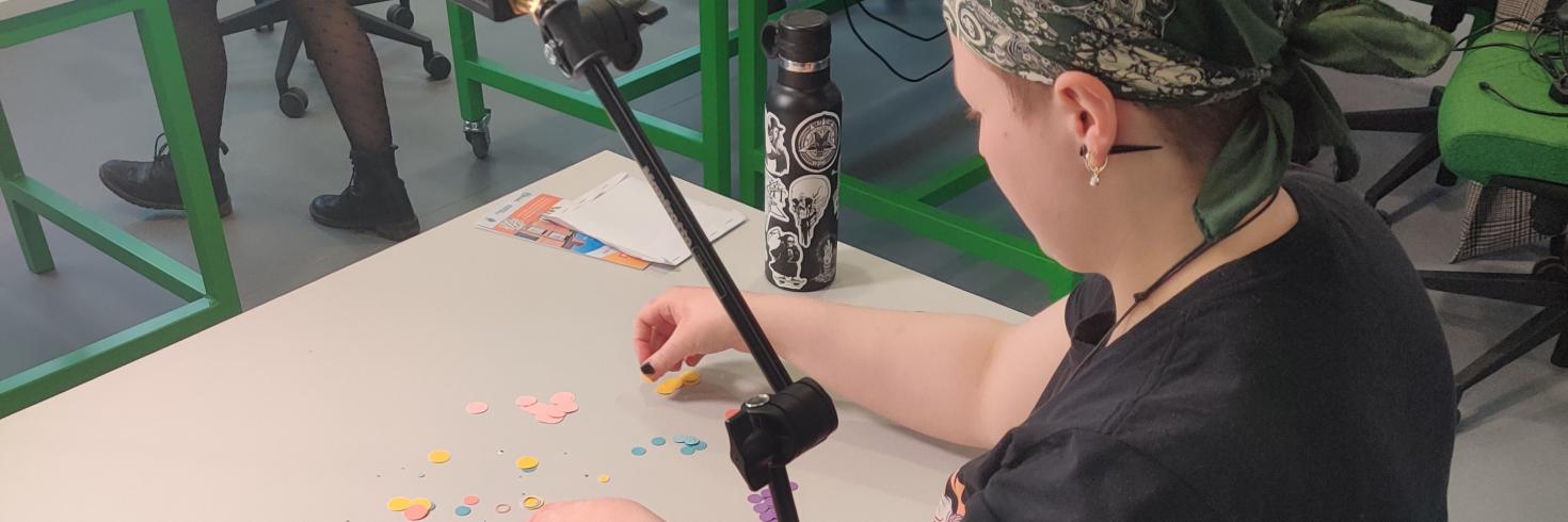 Young female filming a stop-motion animation