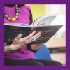 A photo of a woman from the shoulders down reading a book
